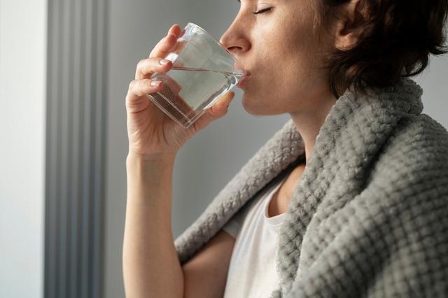 close-up-woman-drinking-water_23-2149149809
